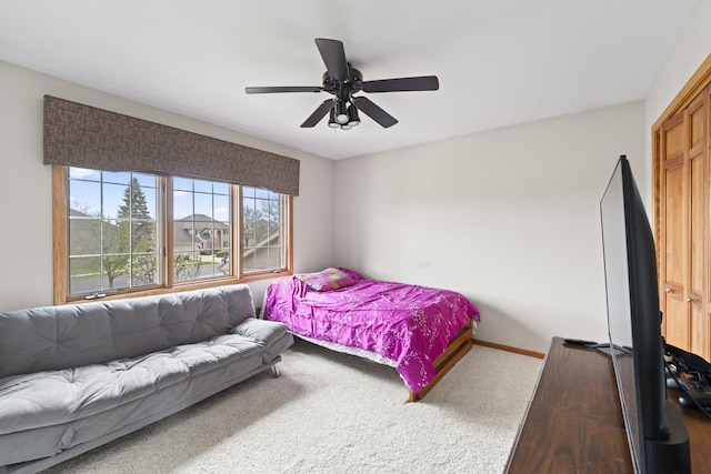 bedroom featuring baseboards, a ceiling fan, and carpet flooring