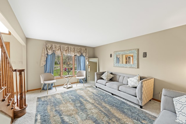 carpeted living area featuring baseboards and stairs