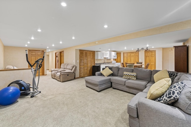 living room featuring recessed lighting, bar area, and light carpet