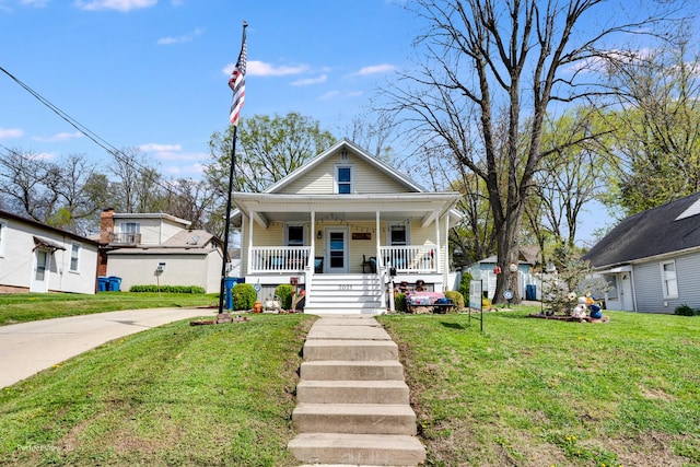 2021 1st St, Peru, IL 61354 - bungalow-style home with covered porch, a front yard, and concrete driveway