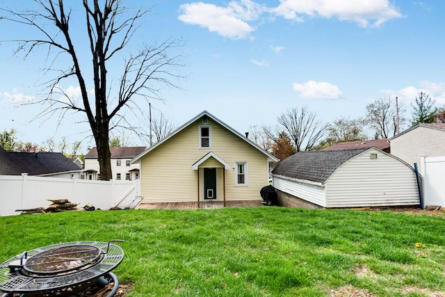 2021 1st St, Peru, IL 61354 - rear view of house featuring an outdoor fire pit, a yard, a storage unit, fence, and a wooden deck