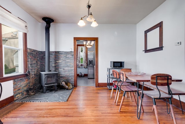2021 1st St, Peru, IL 61354 - dining area featuring an inviting chandelier, wood finished floors, and a wood stove