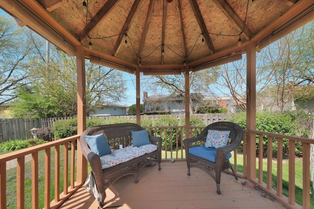 deck featuring a gazebo and fence