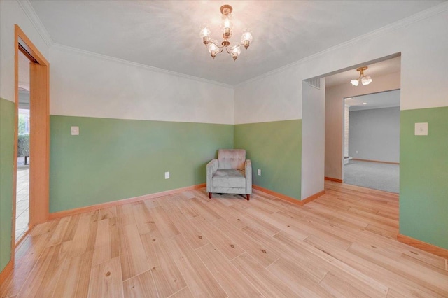 unfurnished room with crown molding, baseboards, a notable chandelier, and wood finished floors