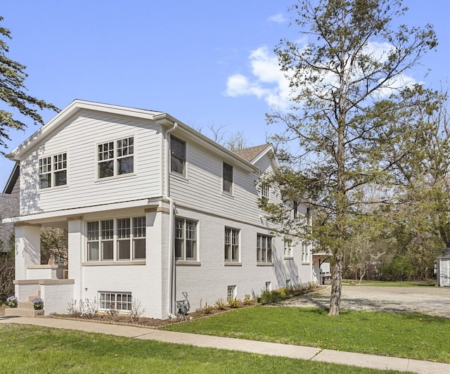 91 Wagner Rd, Northfield, IL 60093 - view of property exterior featuring a lawn and brick siding