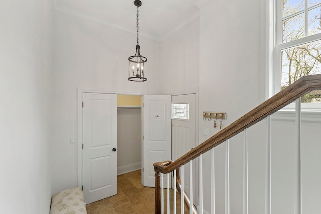 91 Wagner Rd, Northfield, IL 60093 - entrance foyer with stairs, a high ceiling, a chandelier, and ornamental molding