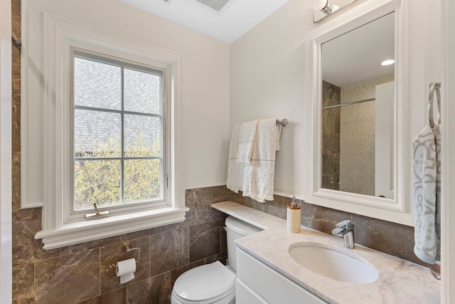 91 Wagner Rd, Northfield, IL 60093 - bathroom with toilet, a healthy amount of sunlight, vanity, and tile walls