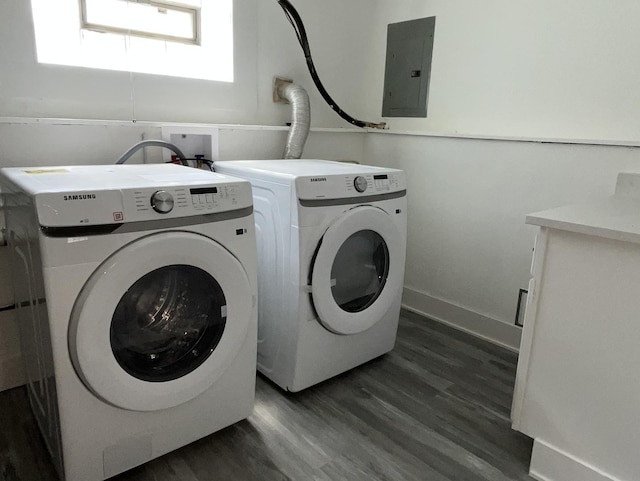 washroom featuring wood finished floors, laundry area, washer and clothes dryer, and electric panel