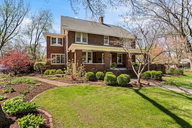 915 W Clark St, Champaign, IL 61821 - view of front of property with brick siding, a front lawn, a chimney, and a porch