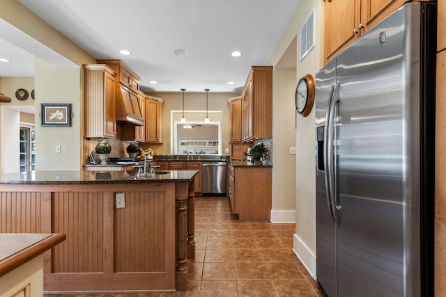 915 W Clark St, Champaign, IL 61821 - kitchen featuring appliances with stainless steel finishes, dark tile patterned flooring, pendant lighting, backsplash, and recessed lighting
