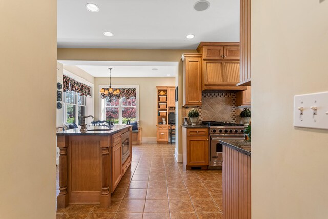 915 W Clark St, Champaign, IL 61821 - kitchen with appliances with stainless steel finishes, decorative backsplash, a sink, recessed lighting, and a chandelier