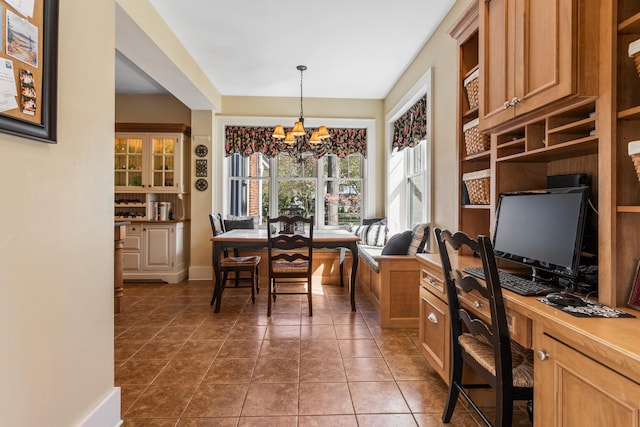 915 W Clark St, Champaign, IL 61821 - dining area featuring a chandelier, an office area, tile patterned floors, and baseboards