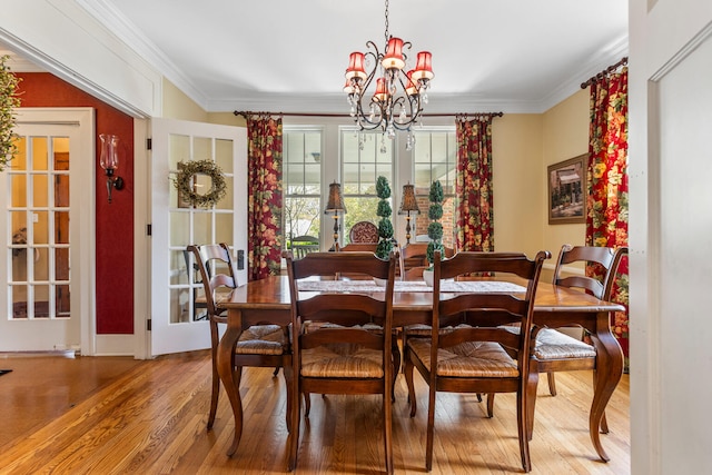 915 W Clark St, Champaign, IL 61821 - dining space featuring a chandelier, wood finished floors, and ornamental molding