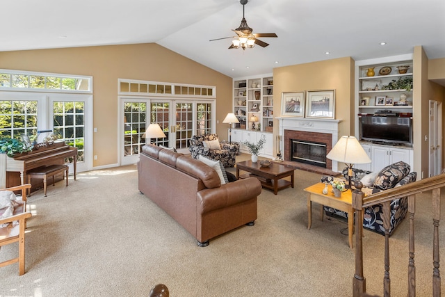 915 W Clark St, Champaign, IL 61821 - living room with light carpet, a fireplace, lofted ceiling, a ceiling fan, and built in shelves