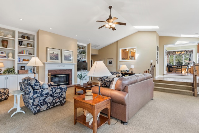 915 W Clark St, Champaign, IL 61821 - living room featuring ceiling fan, light carpet, a fireplace, vaulted ceiling, and built in shelves