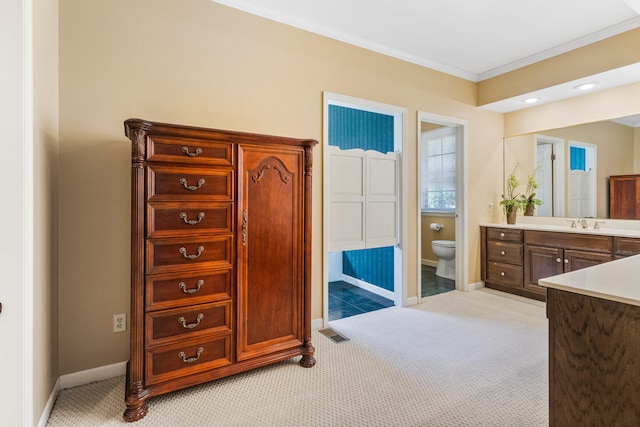 915 W Clark St, Champaign, IL 61821 - bathroom featuring vanity, ornamental molding, toilet, and baseboards