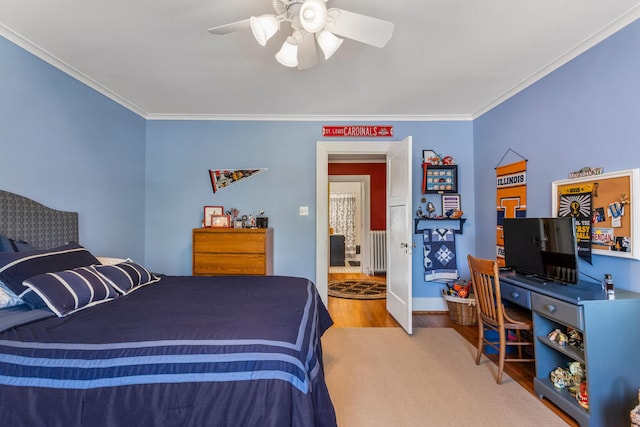 915 W Clark St, Champaign, IL 61821 - bedroom featuring ornamental molding, wood finished floors, a ceiling fan, baseboards, and radiator heating unit