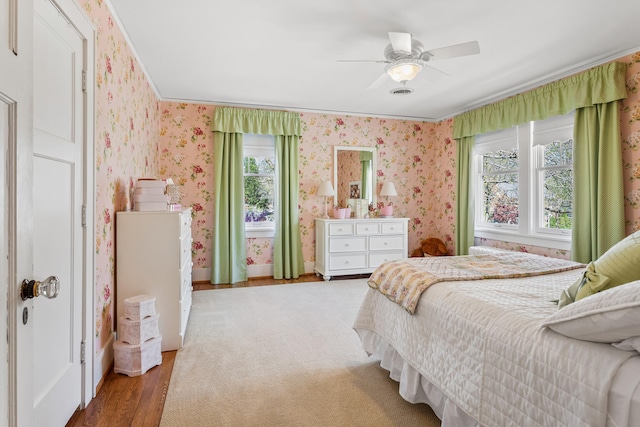 915 W Clark St, Champaign, IL 61821 - bedroom featuring wood finished floors, wallpapered walls, crown molding, and ceiling fan