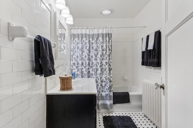 915 W Clark St, Champaign, IL 61821 - full bathroom with radiator, shower / bath combo, vanity, tile walls, and tile patterned floors