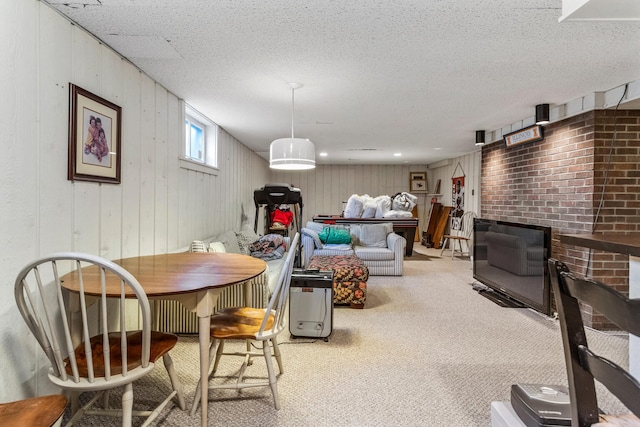 915 W Clark St, Champaign, IL 61821 - dining room featuring carpet floors, a textured ceiling, and wood walls