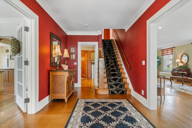 915 W Clark St, Champaign, IL 61821 - stairway featuring radiator heating unit, crown molding, baseboards, wood finished floors, and french doors