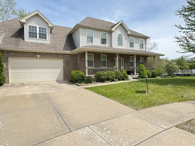 colonial house with a porch, a front yard, brick siding, concrete driveway, and a shingled roof