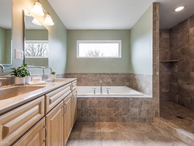 bathroom featuring double vanity, a sink, and a garden tub