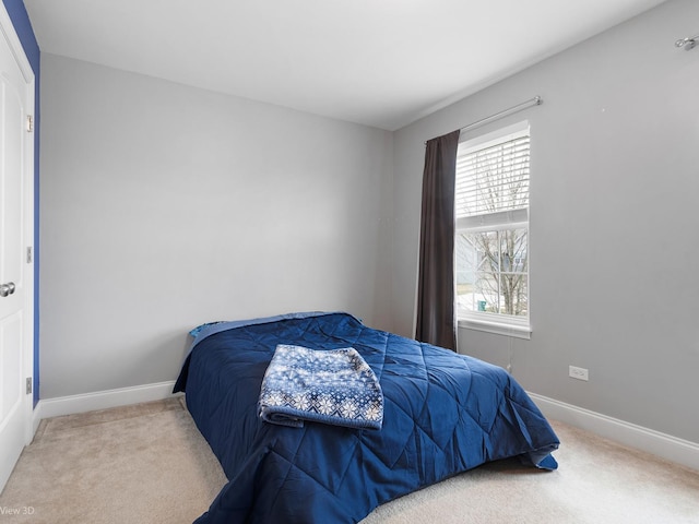 carpeted bedroom with baseboards and multiple windows