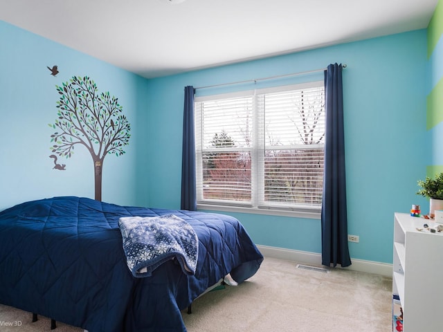 carpeted bedroom with baseboards and visible vents