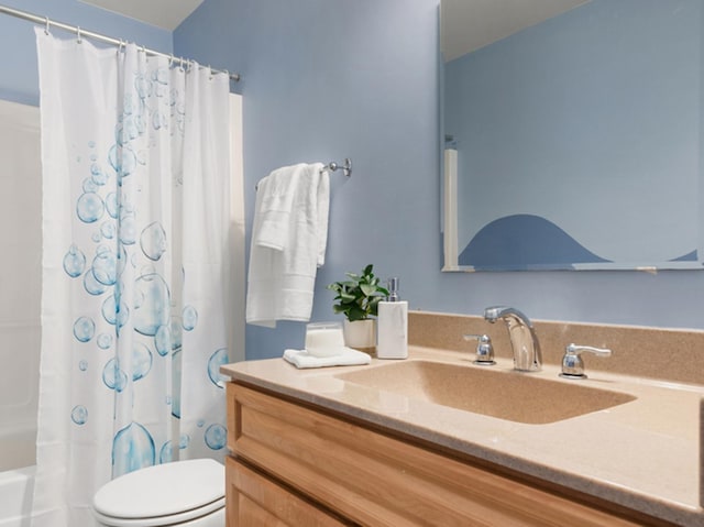 bathroom with toilet, shower / bath combo with shower curtain, and vanity