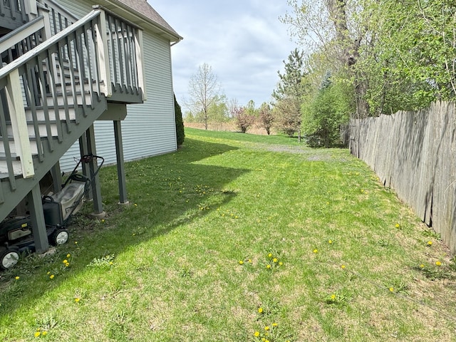 view of yard featuring stairs, fence, and a wooden deck