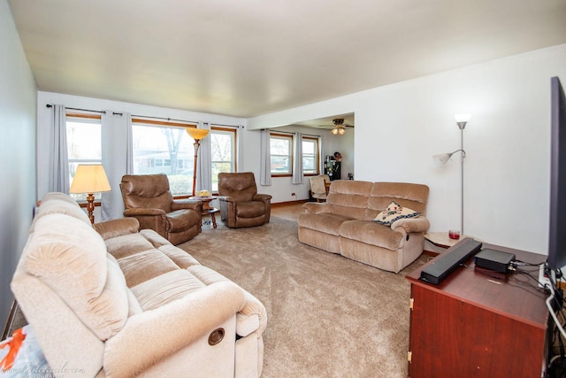 living area featuring a ceiling fan and carpet flooring