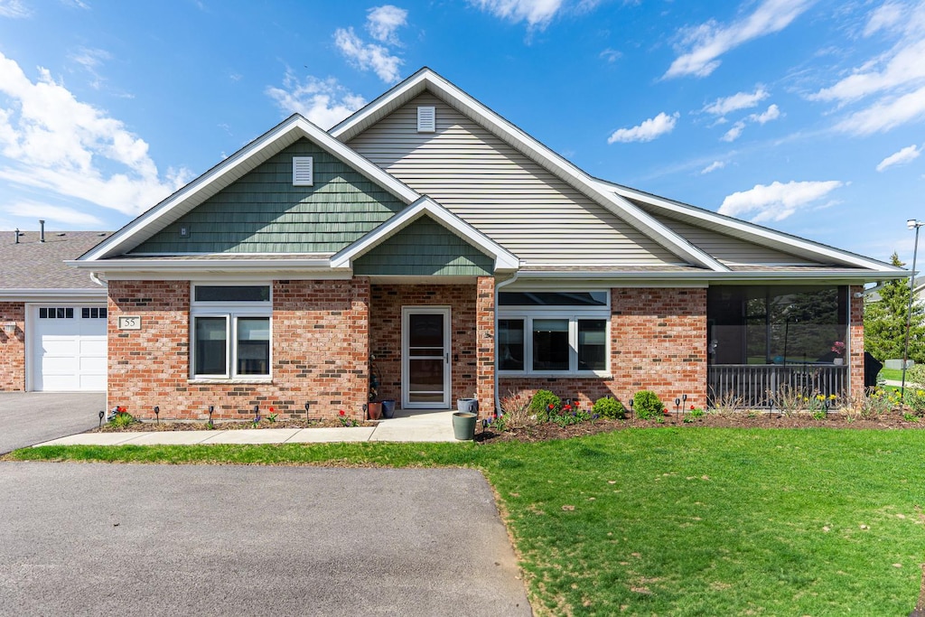 55 Briden Ln Unit 55, Sycamore, IL 60178 - view of front of property featuring aphalt driveway, brick siding, and a front yard