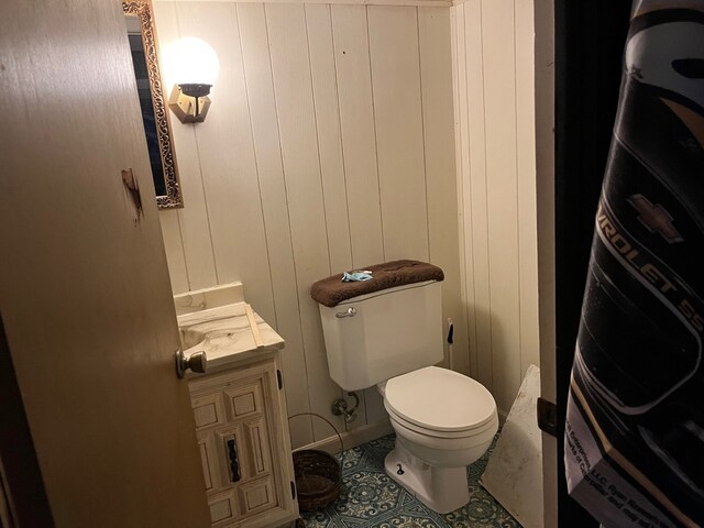 bathroom featuring tile patterned flooring, toilet, and vanity