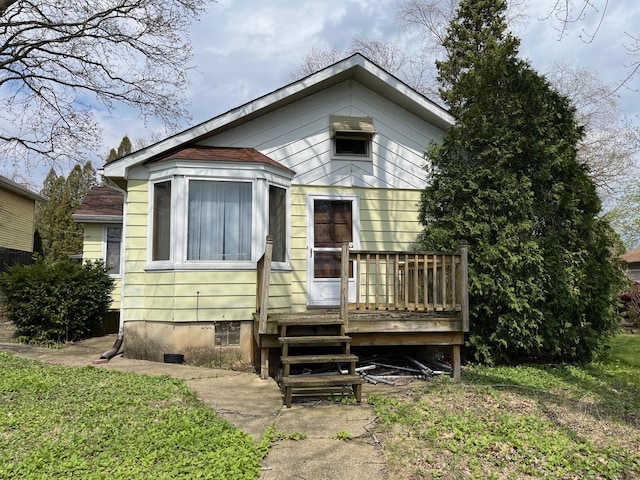 bungalow-style home with a wooden deck and crawl space