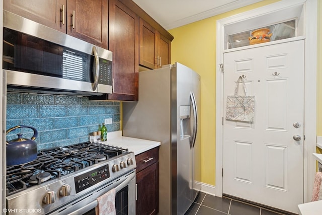 6133 N Hoyne Ave Unit 1, Chicago, IL 60659 - kitchen featuring tasteful backsplash, light countertops, baseboards, appliances with stainless steel finishes, and dark tile patterned floors