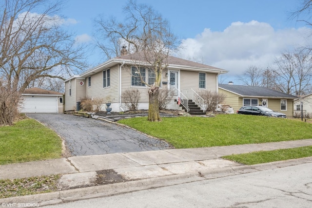 241 Tiverton Ln, Steger, IL 60475 - view of front of home featuring an outdoor structure, a garage, a front lawn, and a chimney