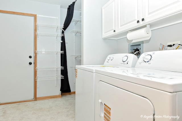 washroom with washing machine and clothes dryer and cabinet space