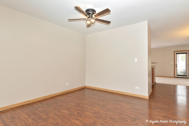 unfurnished room with wood finished floors, a ceiling fan, and baseboards