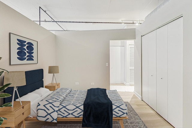 bedroom featuring light wood-style flooring and a closet