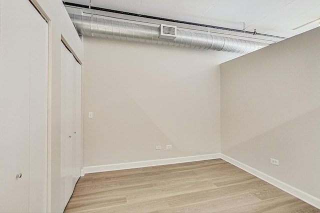 spacious closet with light wood-type flooring and visible vents