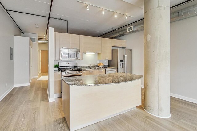 kitchen featuring a sink, light wood-style flooring, rail lighting, appliances with stainless steel finishes, and visible vents