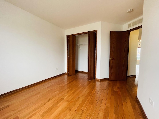 15753 Scotsglen Rd, Orland Park, IL 60462 - unfurnished bedroom with baseboards, light wood-style floors, visible vents, and a closet