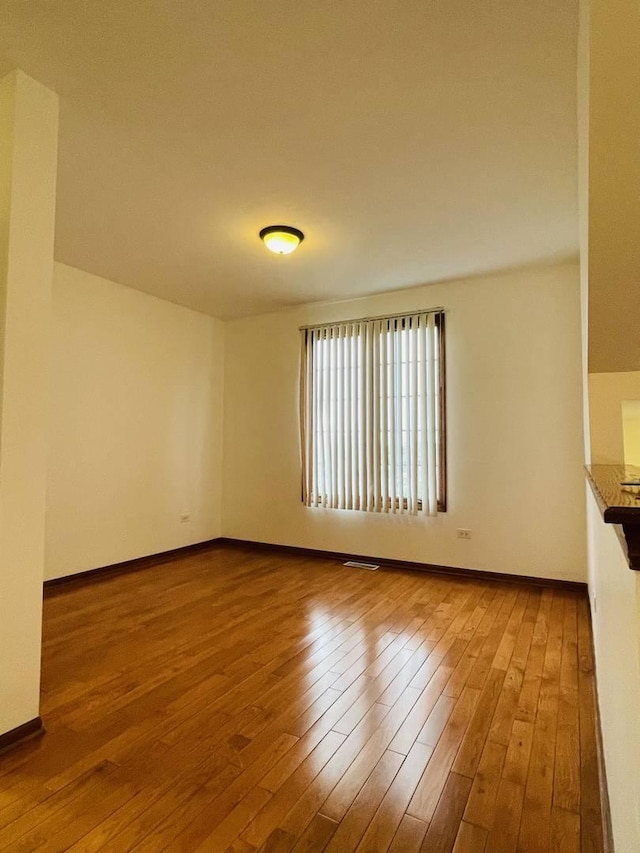 15753 Scotsglen Rd, Orland Park, IL 60462 - empty room featuring wood finished floors and baseboards