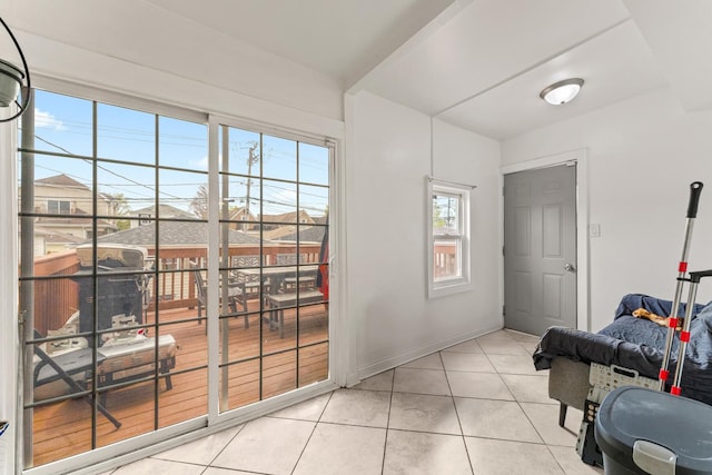interior space with tile patterned floors and baseboards
