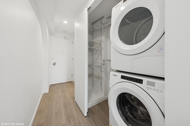 300 N State St Unit 3827, Chicago, IL 60654 - laundry room featuring baseboards, stacked washer / dryer, light wood finished floors, and recessed lighting