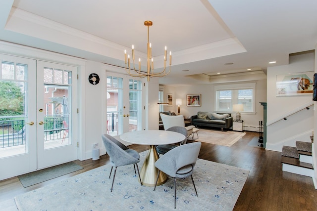 938 Edgemere Ct, Evanston, IL 60202 - dining room with french doors, wood finished floors, a tray ceiling, a chandelier, and a baseboard radiator