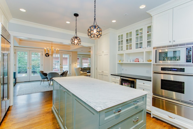 938 Edgemere Ct, Evanston, IL 60202 - kitchen with green cabinetry, built in appliances, crown molding, french doors, and white cabinetry