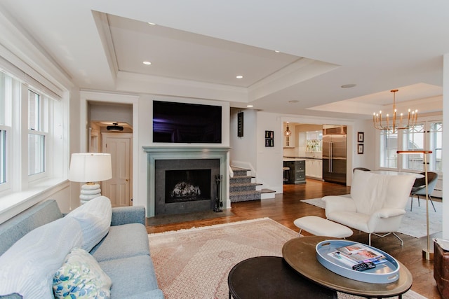 938 Edgemere Ct, Evanston, IL 60202 - living area with a raised ceiling, a fireplace with flush hearth, a chandelier, dark wood finished floors, and recessed lighting