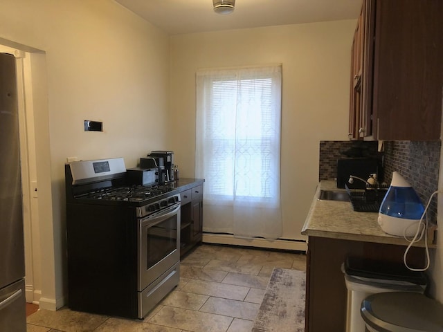 926 S Lathrop Ave, Forest Park, IL 60130 - kitchen featuring decorative backsplash, a baseboard radiator, stainless steel appliances, light countertops, and a sink